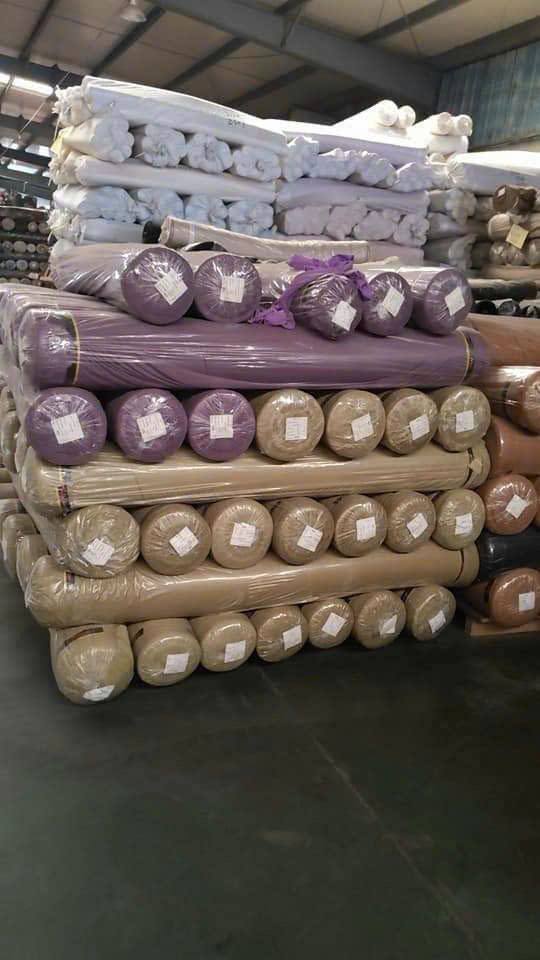 Fabric rolls stacked in a warehouse
